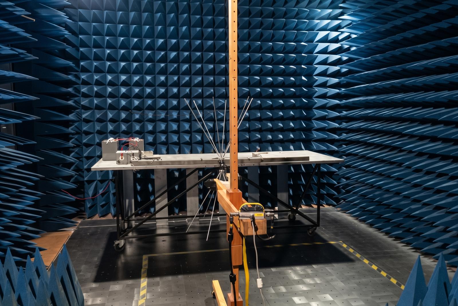 A device under test in an EMC chamber, with the measurement antenna in front